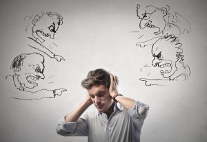 young man covers his ears with his hands