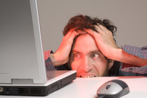 Man Looking At Computer In Desperation